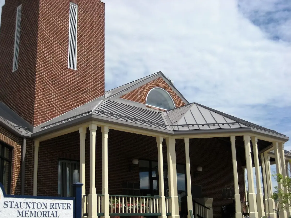 Skilled roofing craftsmen working on a residential roof in Harrisonville